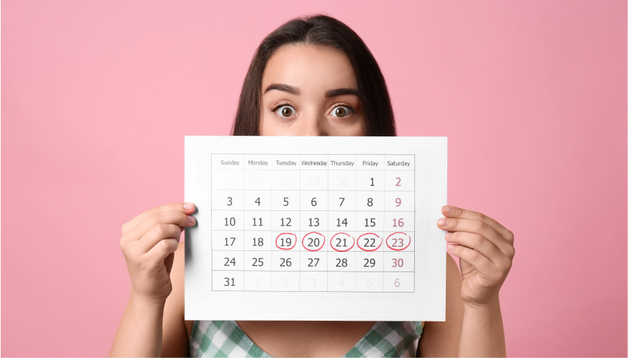 Девушка с менструальным календарем в руках